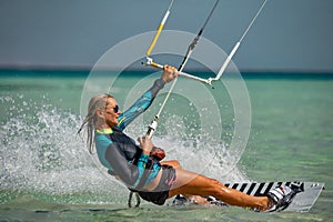 Kite surfer woman rides with kiteboard