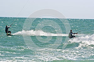 Kite surfers on a choppy sea