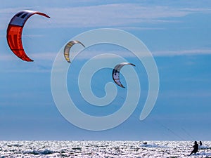 3 kite surfers on the sea