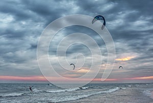 Kite surfers at sunset