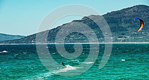 Kite surfing in ocean waves at summer