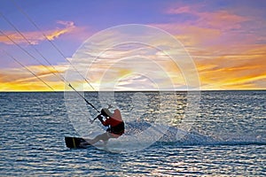 Kite surfing at Palm Beach on Aruba in the Caribbean Sea at sunset