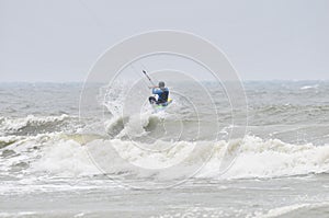 Kite-surfing in spray.