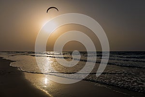 Kite surfing sunset alone in the ocean