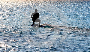 Kite surfing at sunset. Silouette of kite surfer photo