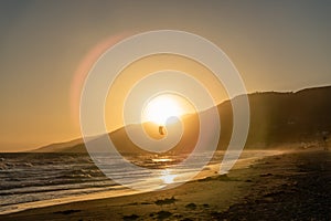 Kite surfing at sunset at Zuma beach, Malibu, California