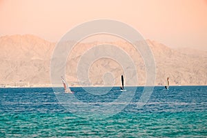 .Kite Surfing and Windsurfing in Eilat. Azure sea against the background of mountains, Khamsin in Israel