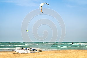 Kite surfing in windy beach with windsurf board photo