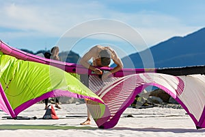 Kiteboarder on the beach prepare sport equipment for riding. Squamish,BC,Canada. Squamish watersports