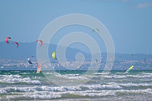 Kiteboarding kitesurfing kiteboarder kitesurfer kites on the ocean beach