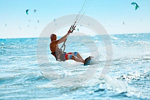Kiteboarding, Kitesurfing. Water Sports. Kitesurf Action On Wave photo