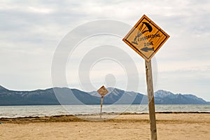 Kiteboarding, wooden kite surfing sign on beach