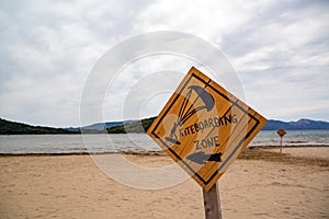 Kiteboarding, wooden kitesurfing sign on beach