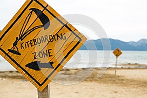 Kiteboarding, wooden kitesurfing sign on beach