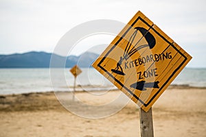 Kiteboarding, wooden kitesurfing sign on beach