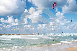 Kiter with dark pink kite in the air at Tel Aviv beach