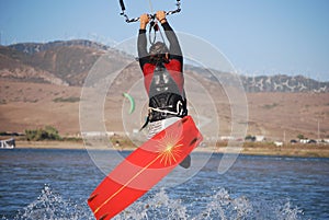 Kiter flying on the waves near Tarifa, Spain photo