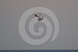 Kiter jumps high above the water at sunset on Patara beach