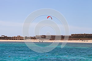 Kiter in the lagoon of the Red Sea on the background of an unfin