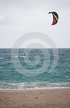 A kitesurfer in the distance off the coast of Uoleva in Tonga