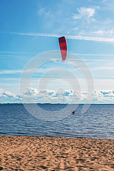 The kitesurfer enters the water