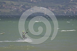 Kitesurfer Gliding Across Lake NeuchÃ¢tel Near Yvonand on a Clear Windy Day photo