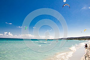 A kitesurfer gliding near the beach La Cinta, Sardinia