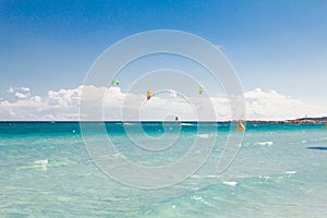 A kitesurfer gliding near the beach La Cinta, Sardinia