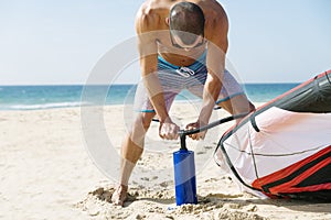 Kitesurfer inflate his kite.