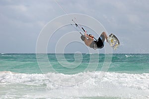 Kitesurfer jumping wave