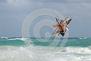 Kitesurfer jumping waves