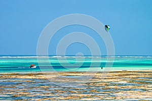 Kitesurfer at low tide on beach in Zanzibar