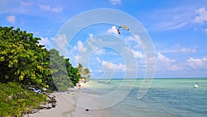 Kitesurfer over a beautiful tropical beach and pacific crystal turquoise water. Cayo Guillermo, Cu