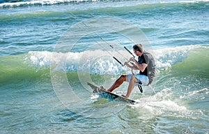 Kitesurfer riding on Kiteboard on the beach in Ulcinj, Montenegr photo