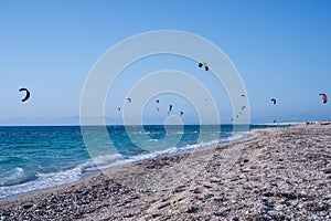 Kitesurfers on the beach in Greece photo