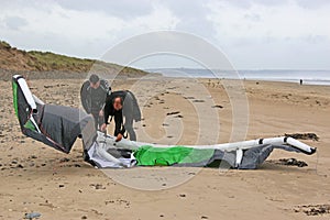 Kitesurfers preparing kite photo