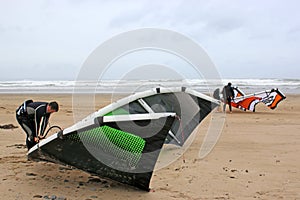 Kitesurfers preparing kites photo