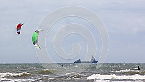 Kitesurfers on the sea photo