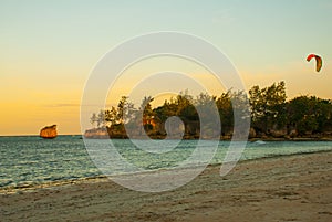 Kitesurfing. Evening landscape of a small island and the sea. Boracay, Philippines.