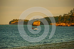 Kitesurfing. Evening landscape of a small island and the sea. Boracay, Philippines.