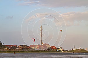 Kitesurfing in front of village photo