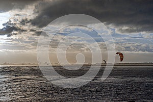 kitesurfing at The Peninsula of Howth Head in sunset, Dublin, Ireland,