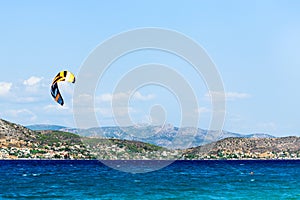 Kitesurfing on the sea. Colorful kites fly in the blue sky.