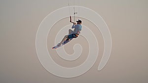 Kitesurfing stunt, jumping in the air and holding the board while flying, Egypt