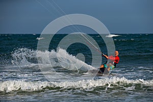 Kitesurfing on the waves of the sea in Mui Ne beach, Phan Thiet, Binh Thuan, Vietnam.