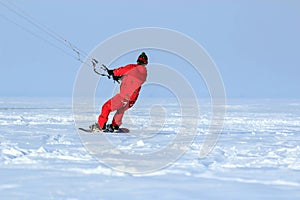 kiting on a snowboard on a frozen lake