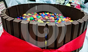 Kitkat chocolate cake with pebbles.Kit Kat broken chocolate bar. Kit Kat is a chocolate biscuit bar. Bar, biscuit, break.With