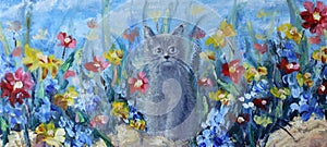 Kitten on a background field of summer flowers