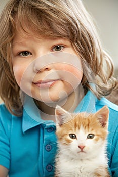 Kitten on hand of the boy outdoors