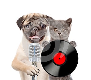 Kitten and puppy singing with microphone a karaoke song. isolated on white background